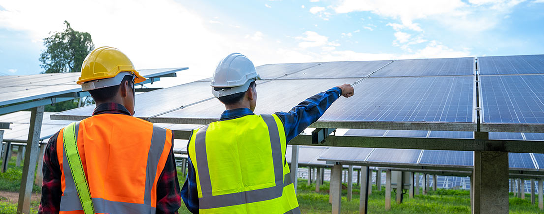 Workers Pointing at Solar Panel