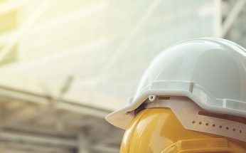 White and Yellow Hardhats Stacked on Top of each other